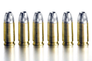 bullets 9mm closeup on brushed metal, white background, high contrast